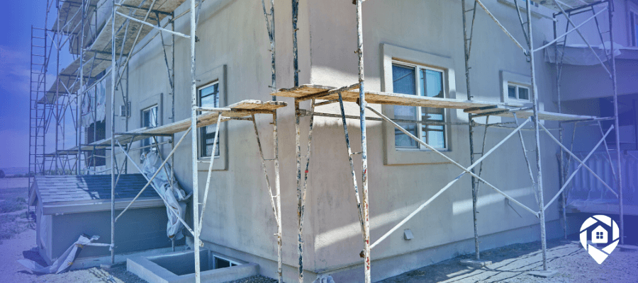 Exterior home renovation in progress showing scaffolding during a real estate investment property rehab.