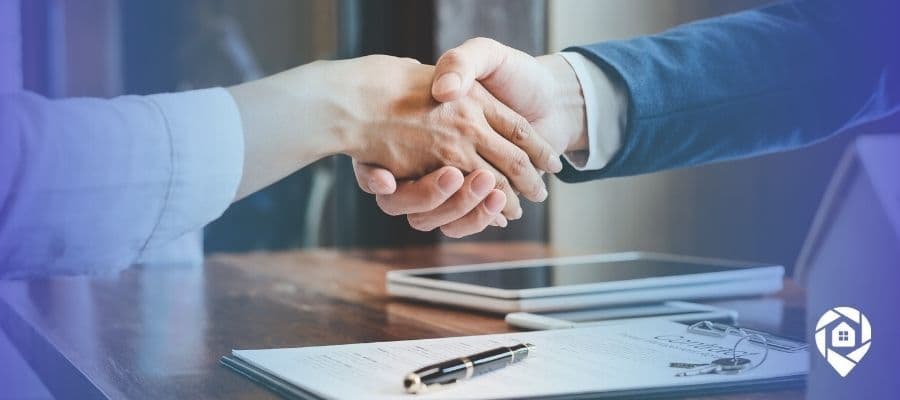 Real estate investor and seller shaking hands after closing a deal, symbolizing successful property negotiation.