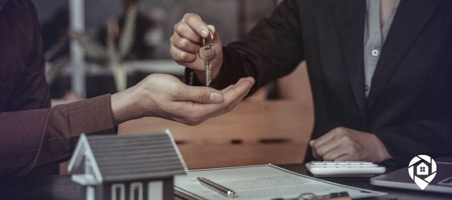 Real estate agent handing house keys to a new homeowner after a successful deal using the 4P success formula.