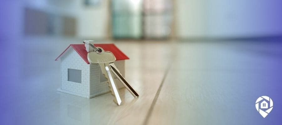 Mini house with keys symbolizes building passive income through ADU real estate investing.