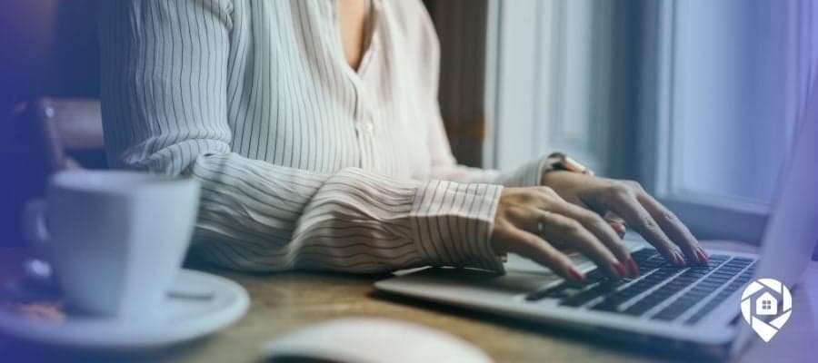 Woman researching virtual wholesaling and tax sale auctions on laptop for real estate investing.