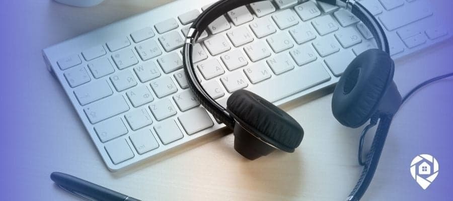 Call center headset on keyboard – real estate cold calling and lead generation tools.