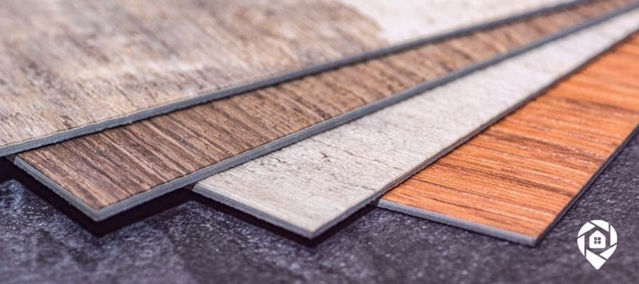 Close-up of luxury vinyl plank (LVP) flooring samples in various wood-style finishes, showcasing durability and modern design options.