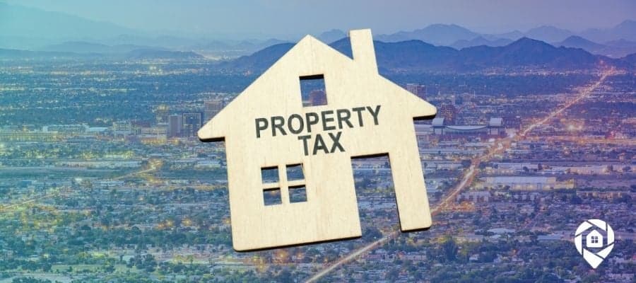 A wooden house cut out with property tax written on it over Arizona to symbolize tax deed sales Arizona.