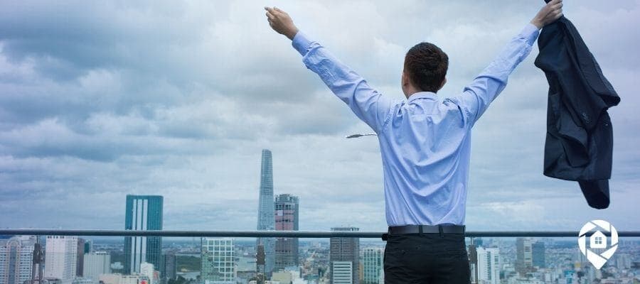 Man celebrating financial freedom after leaving corporate job for real estate investing