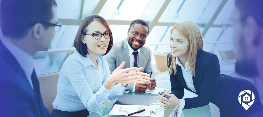Real estate professionals building trust through strategic conversations during a team meeting.