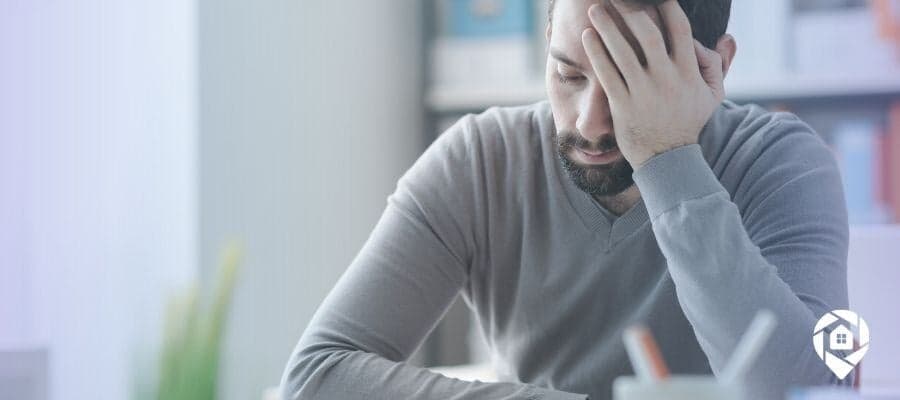 Frustrated real estate investor learning from costly mistakes.