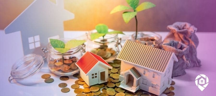 Small houses on a pile of coins to symbolize accessing the MLS database.