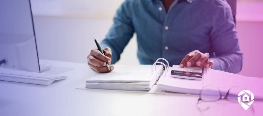 A person searching through public records and copying it into their notebook