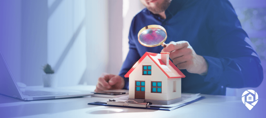 Real estate investor analyzing property deal using model house and magnifying glass, ARV and repair cost evaluation concept