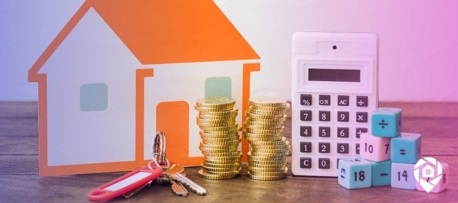 Stacks of coins and a calculator with a house to determine the cost basis of a rental property,