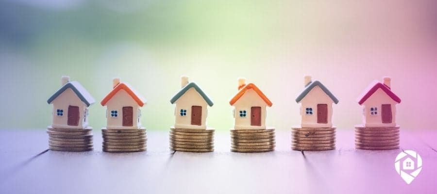 A line of tiny houses on coins to symbolize How to Find Profitable Investment Properties for Sale