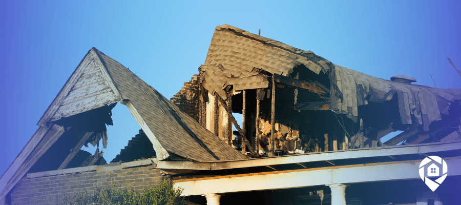 Fire-damaged house with collapsed roof, representing real estate investment opportunities in distressed properties.