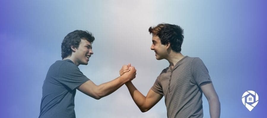 Two real estate partners celebrating success after closing deals in their lean $1M wholesaling business.
