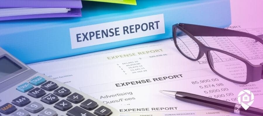 An expense report binder on top of real estate operating expense sheets.