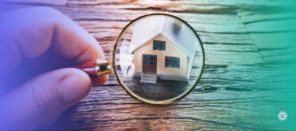 Magnifying glass over a small home
