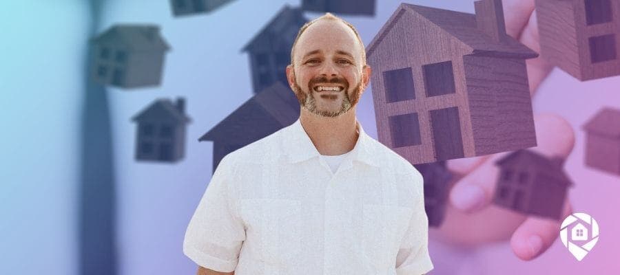 Michael Breedlove with floating house models, symbolizing property investment and financial success.