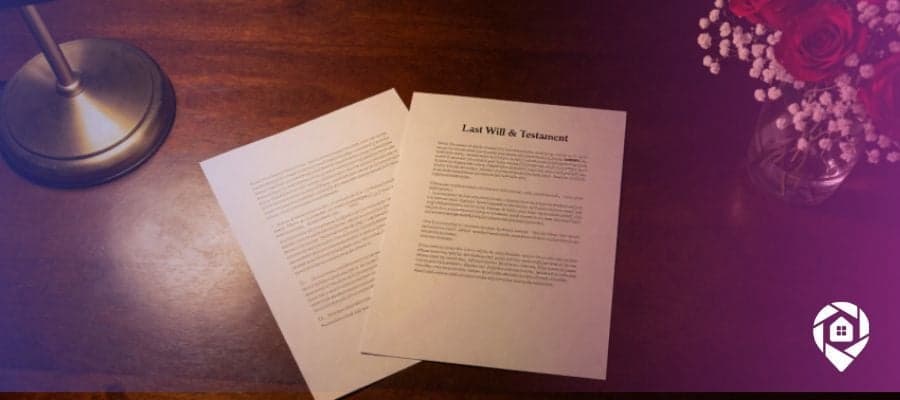 Dark wood desktop with a lamp on the left and a vase with roses and baby's breath on the right. In the center are two sheets of paper titled "Last Will & Testament".