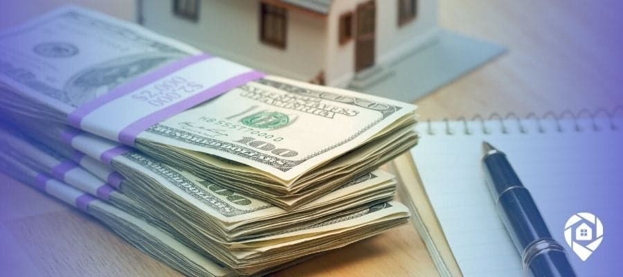 Stacks of cash, a model house, and a notepad representing real estate funding and investment planning strategies.
