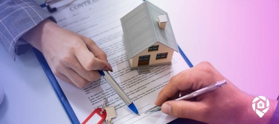 Two different peoples hands over the contract for a tax deed with a small house sitting on top of it.