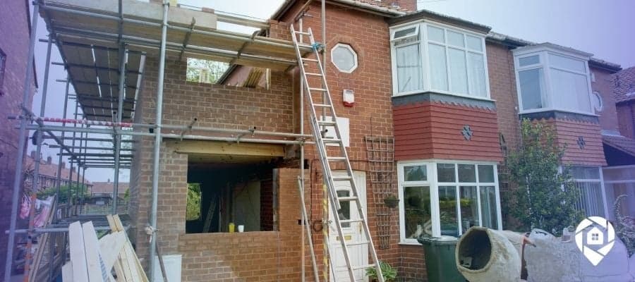 Brick house undergoing renovation for a low-risk fix and flip project using the Revive Method.