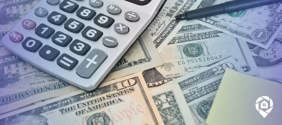 Calculator and cash on table for analyzing seller financing deals in real estate.