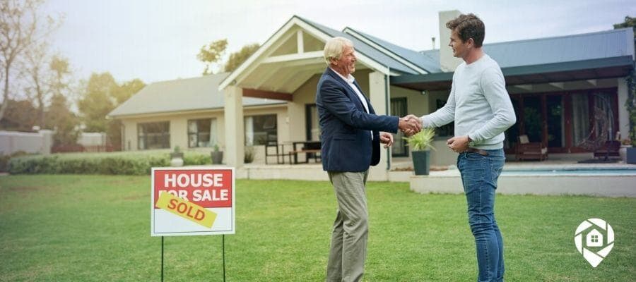 Real estate deal closed: Buyer and seller handshake on sold home.