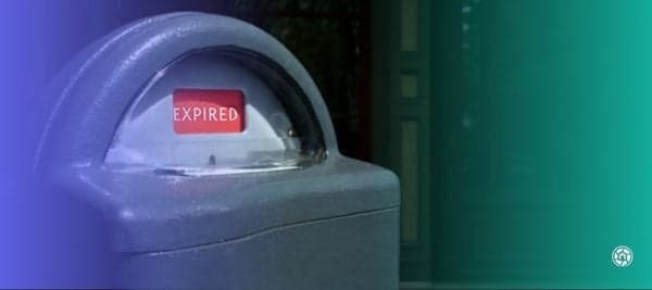 A parking meter showing a red expired tag